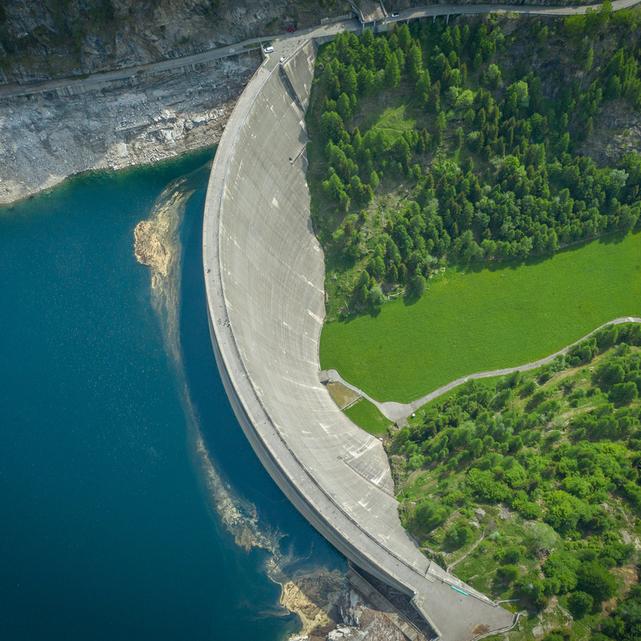 Aerial view of bridge on large dam in Swiss Alps